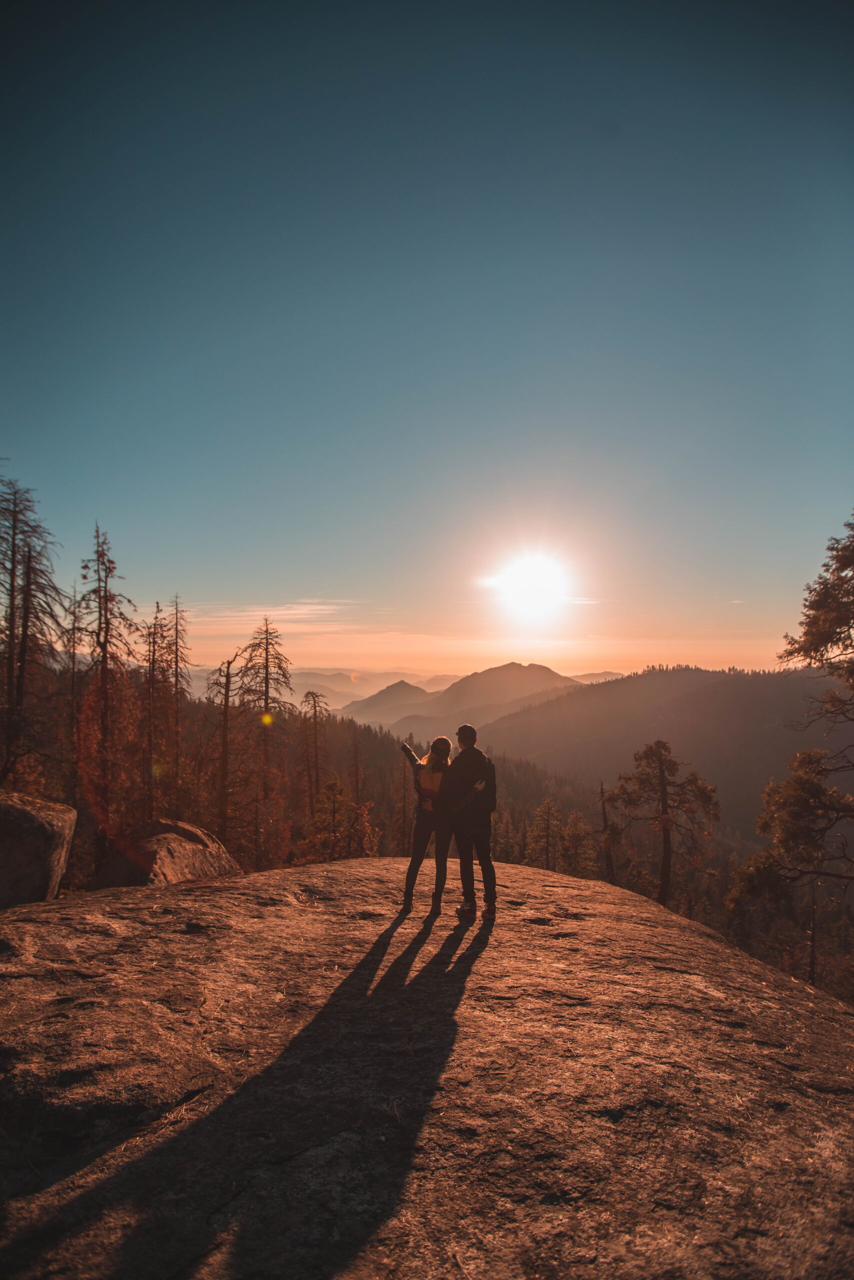 two hikers on a mountain looking at the view